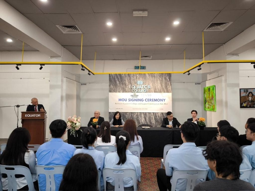 MOU signing ceremony at Equator College with speakers and audience.