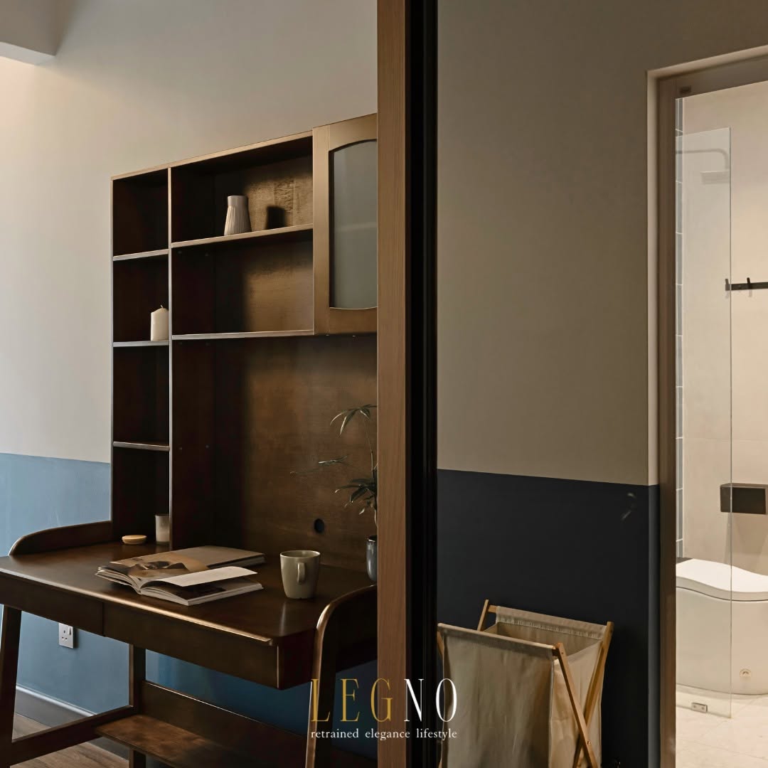 Bedroom study desk with dark timber shelving and blue panelling beside the ensuite bathroom in Penang