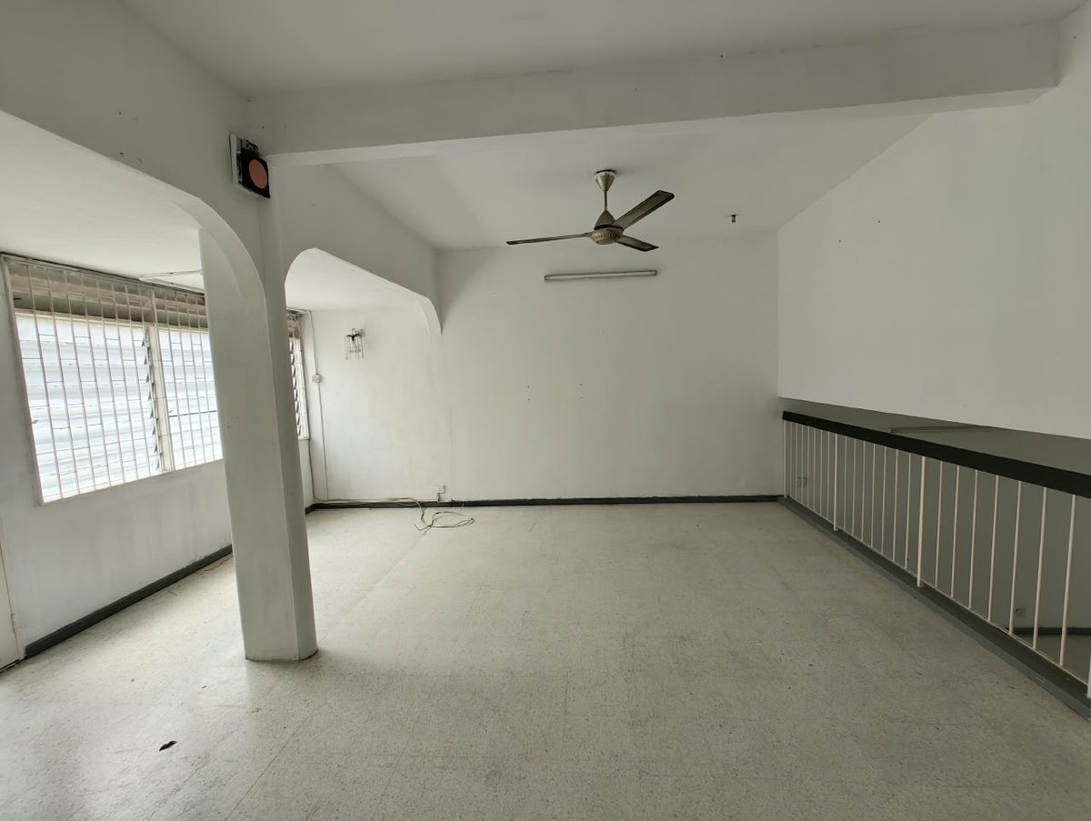 Before renovation: bedroom with old timber wardrobe and patterned floor tiles in the 30-year-old house
