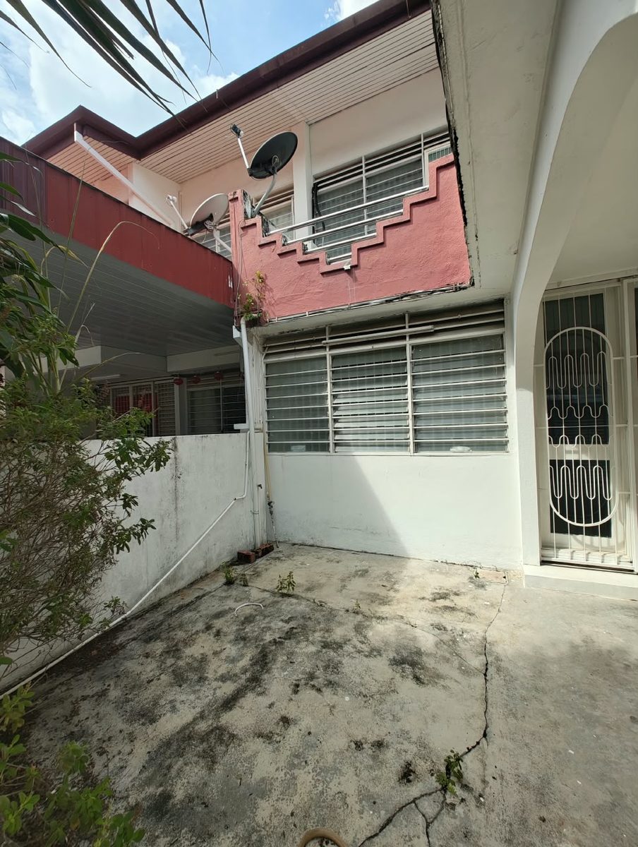 Before renovation: front courtyard and ageing facade with window grilles on a Penang terrace house