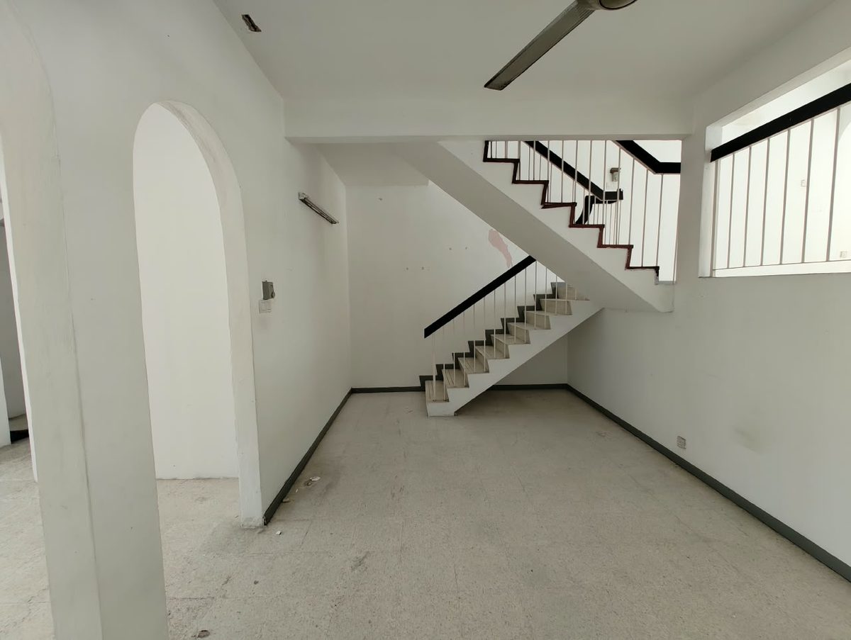 Before renovation: upper floor hall with low balcony railing and dated finishes in a Penang terrace house