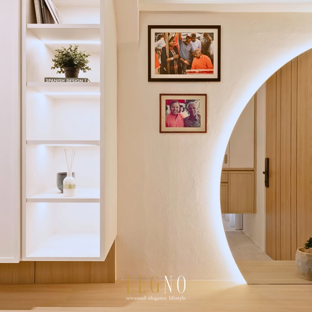 Curved archway with concealed cove lighting opening a longer daylight path through a renovated Penang terrace house