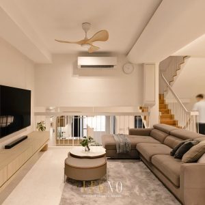 Open-plan living room with sectional sofa and staircase after Penang terrace house renovation by LEGNO