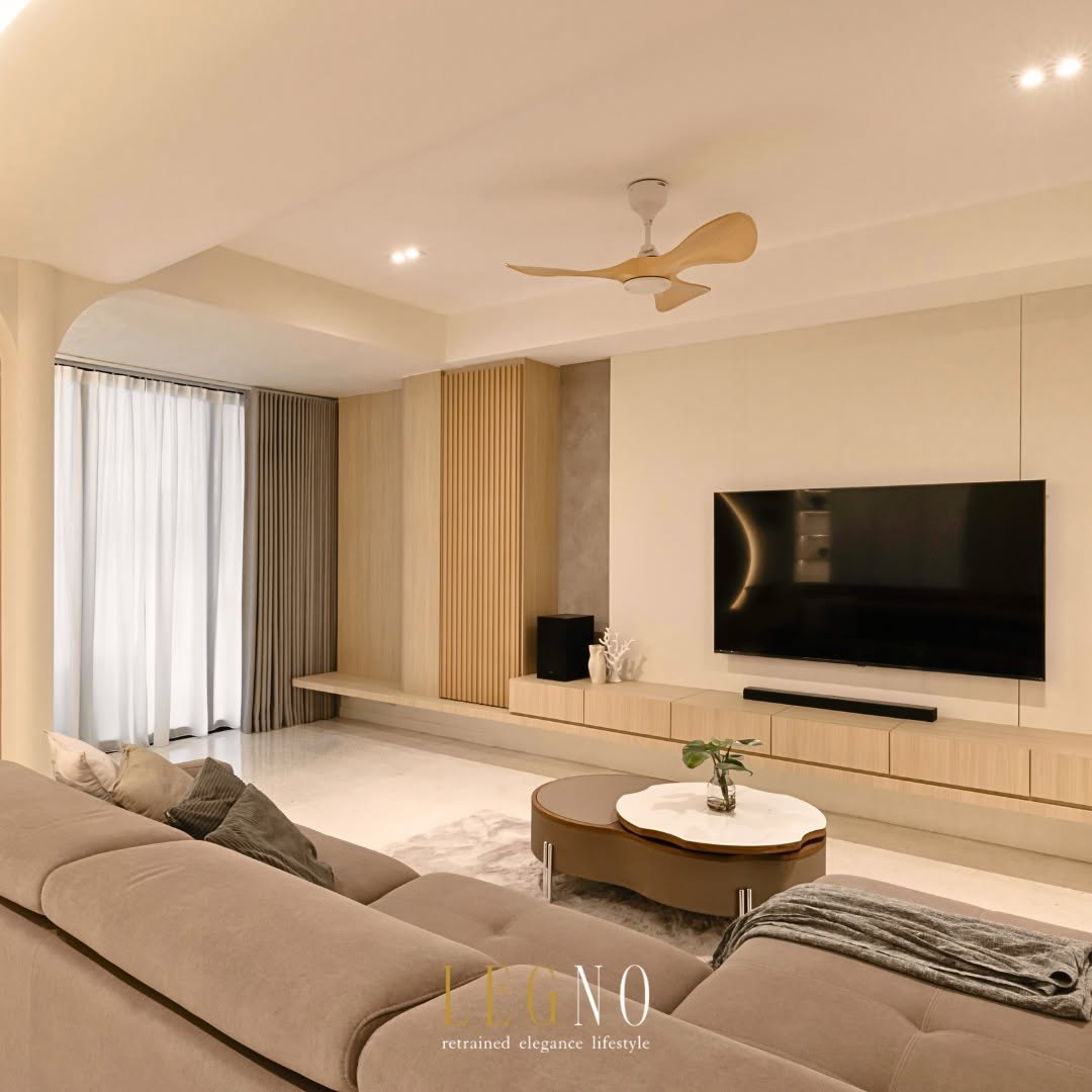 Renovated living room with fluted timber TV feature wall and warm neutral palette in a Penang terrace house